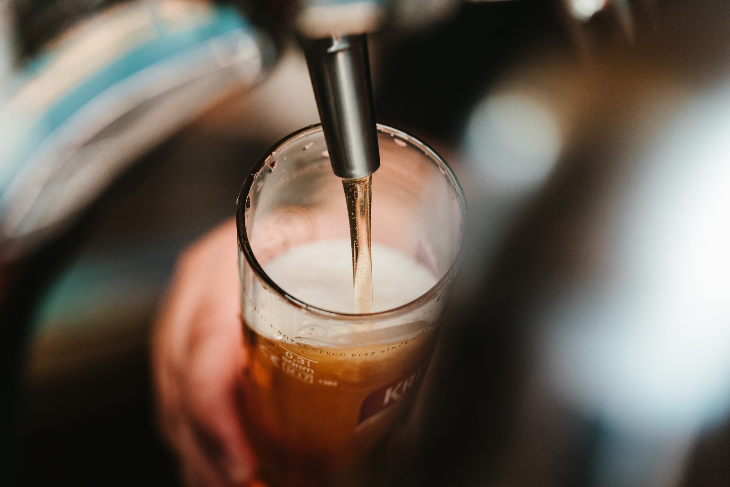 パブのカウンターでグラスに注がれるビールのイメージ