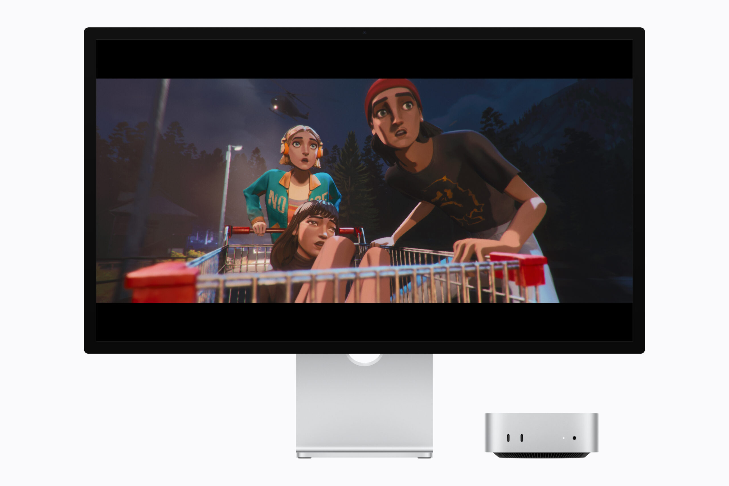 Mac miniとStudio Displayでゲーム「Mixtape」を表示している画面。夜の森でショッピングカートを押す3人のキャラクターが描かれている