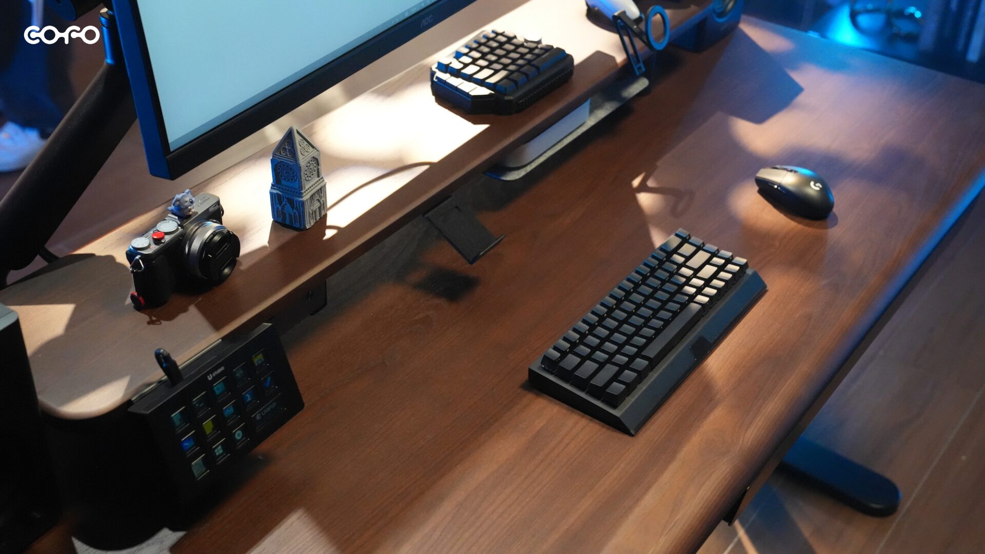 ダークブラウン天板のCOFO Desk Studioにデスクシェルフを設置し、カメラや左手デバイス、キーボードを並べたデスク環境