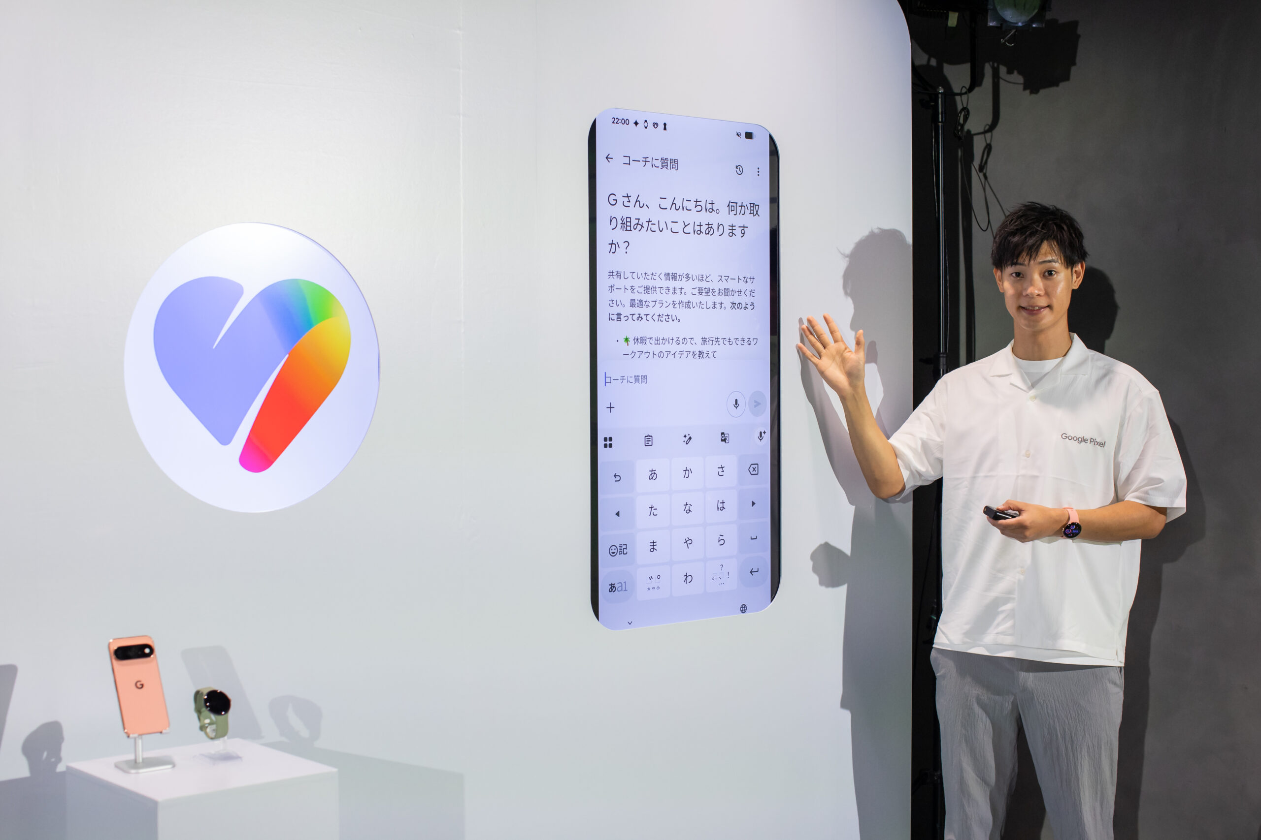 グラデーションのハート型をした Google Health のロゴと、コーチに質問する画面が並んだデモ展示