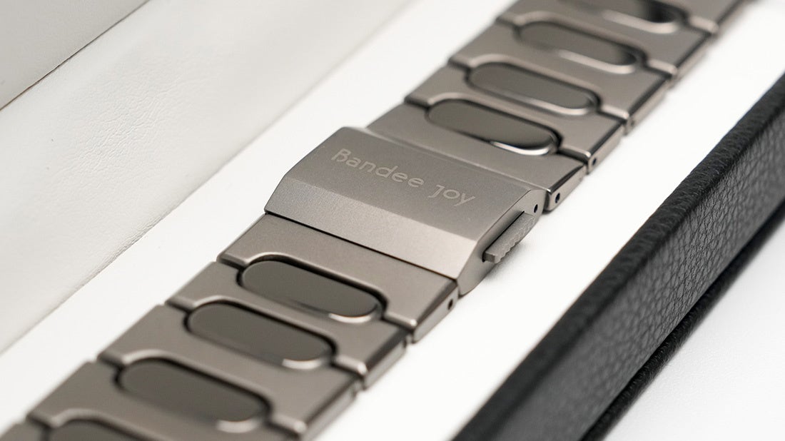 ジャケットの袖口からのぞく、BJ-007 BRIGHT - Blackを装着したApple Watch