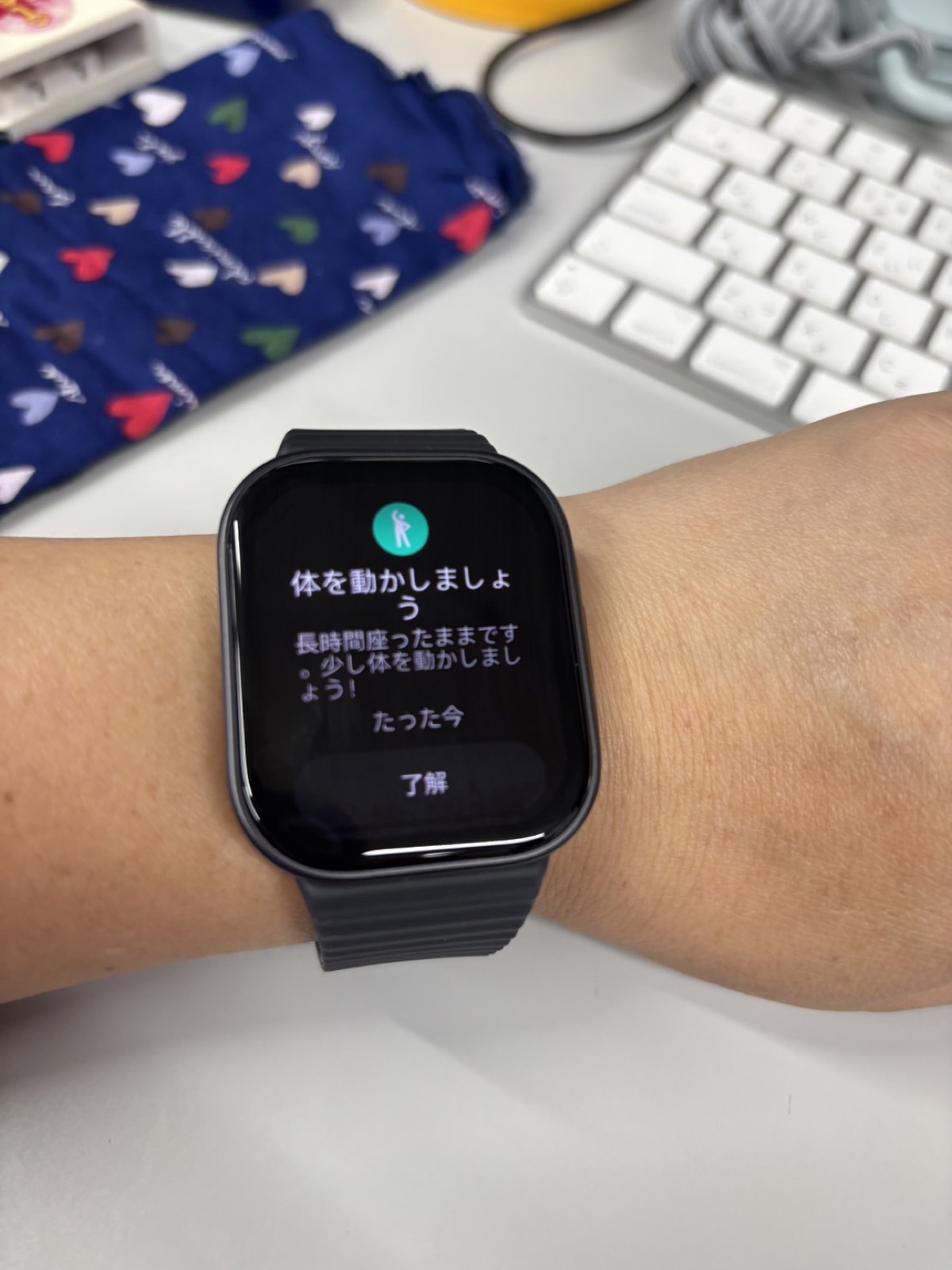 REDMI Watch 6 Liteの画面に「体を動かしましょう　長時間座ったままです。少し体を動かしましょう！」という通知が表示されている