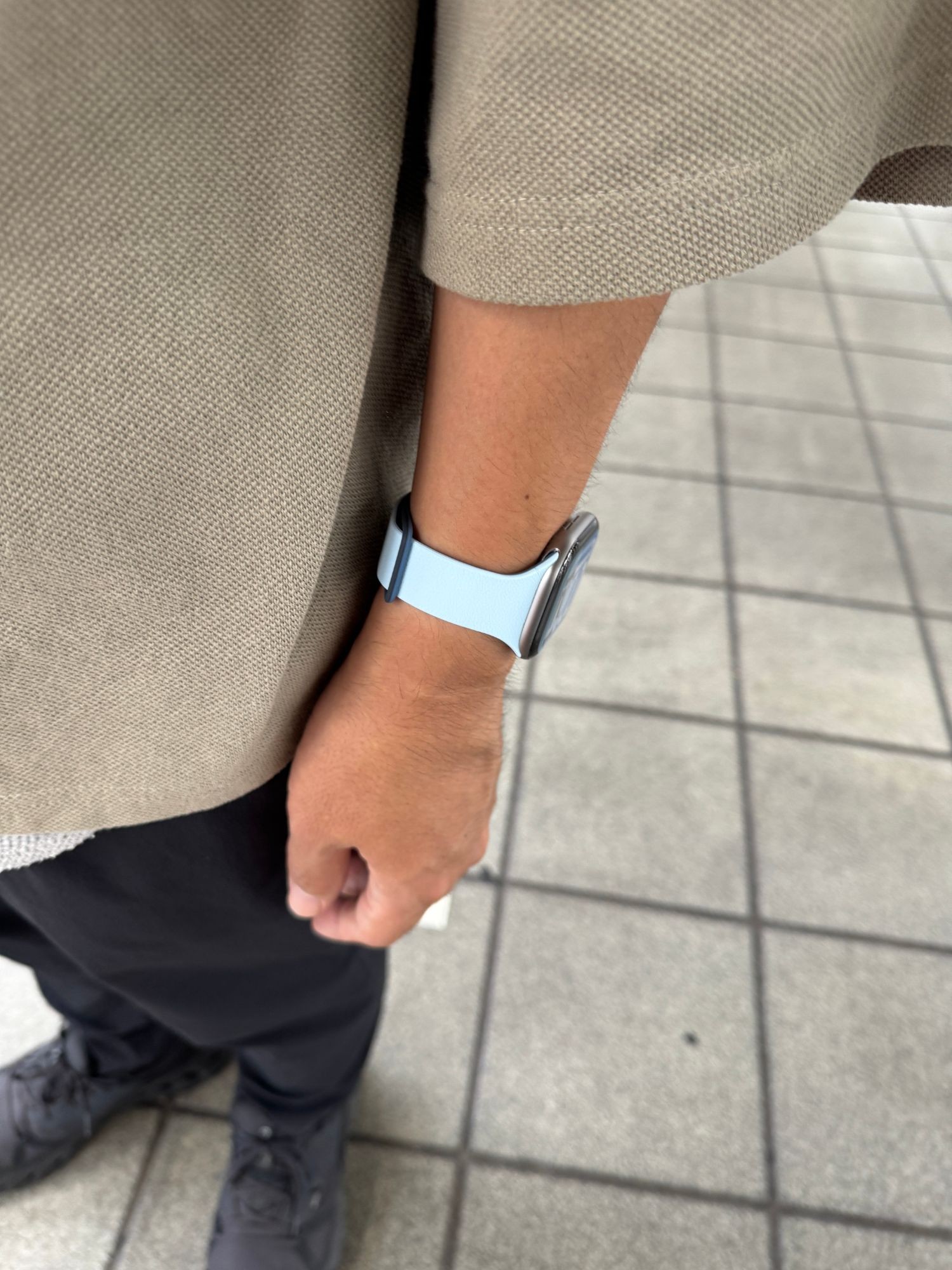 腕を下ろした状態で手首を横から見たところ。明るい水色のバンドが表に出て、端から濃い紺がのぞいている