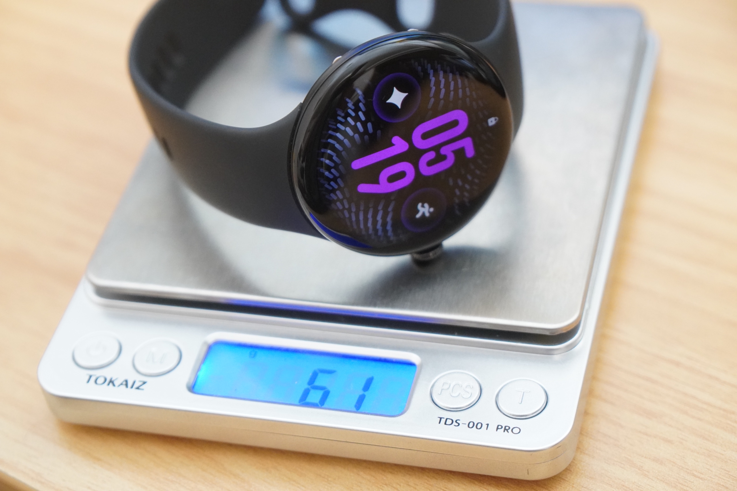 キッチンスケールに載せたPixel Watch 5（45mm）。表示は61gでバンドを含んだ重さ