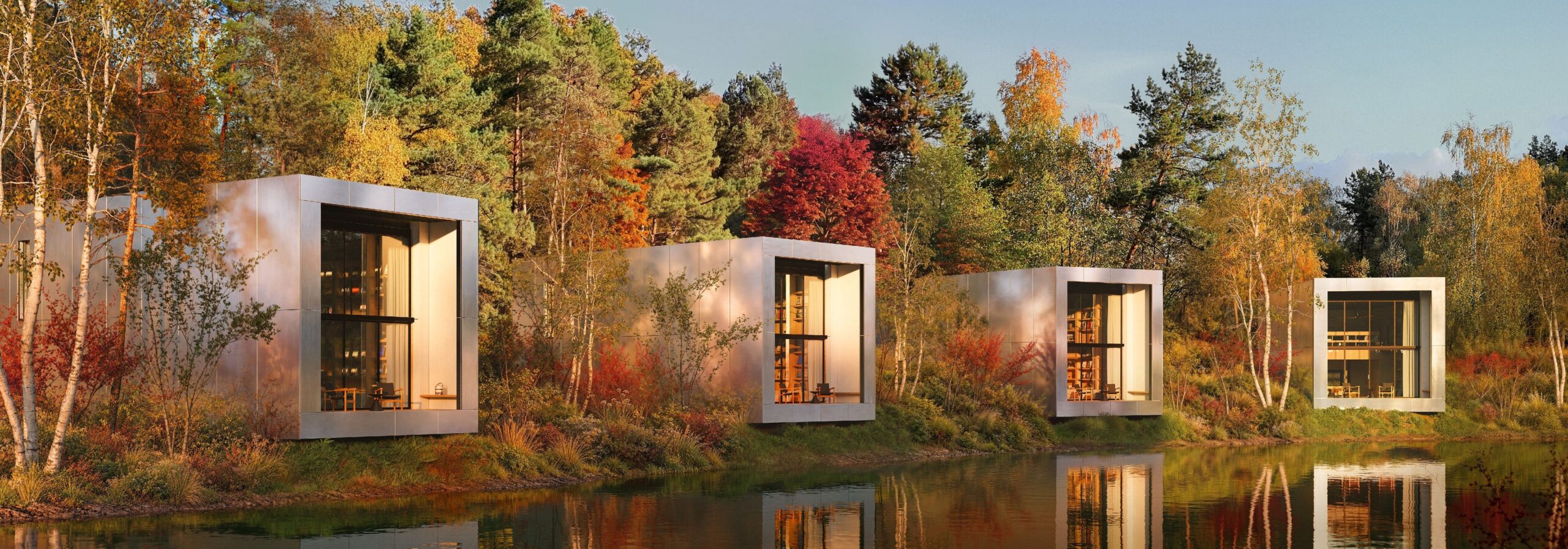 紅葉した森の水辺に、箱形の住宅PODが4棟並んで建つイメージ（CGパース）