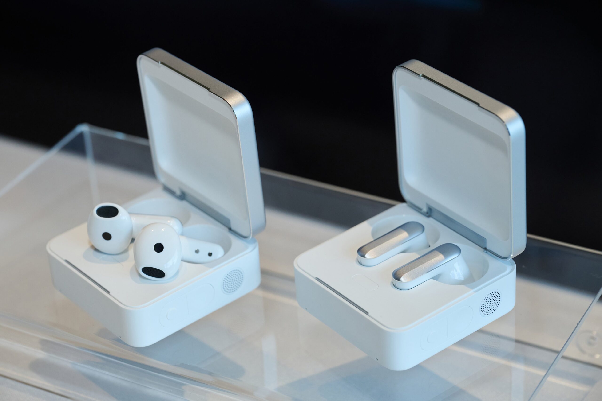 発表会に展示されたPlaud Oneのイヤホンと、ふたを開けた充電ケース