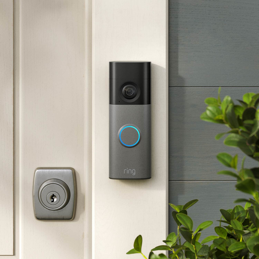 玄関ドア横の壁に取り付けたRing Battery Doorbell 2K。青く光る呼び出しボタンが付いたバッテリー式ドアベル。