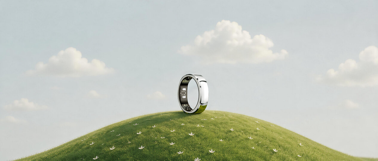 芝生の丘の上に立てて置かれた、銀色のRingConnのスマートリング